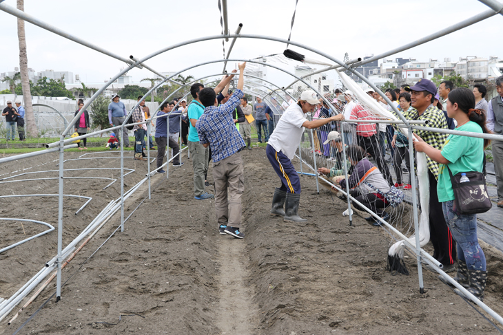 Attendees learn hands-on how to build a tunnel-shaped canopy for growing indigenous gac.