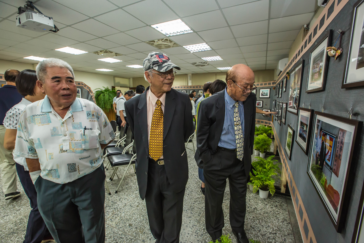 Former Directors and Other Attendees Viewing the Photo Exhibition.
