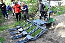 A lecturer introduces a four-pronged millet transplanter to boost efficiency.
