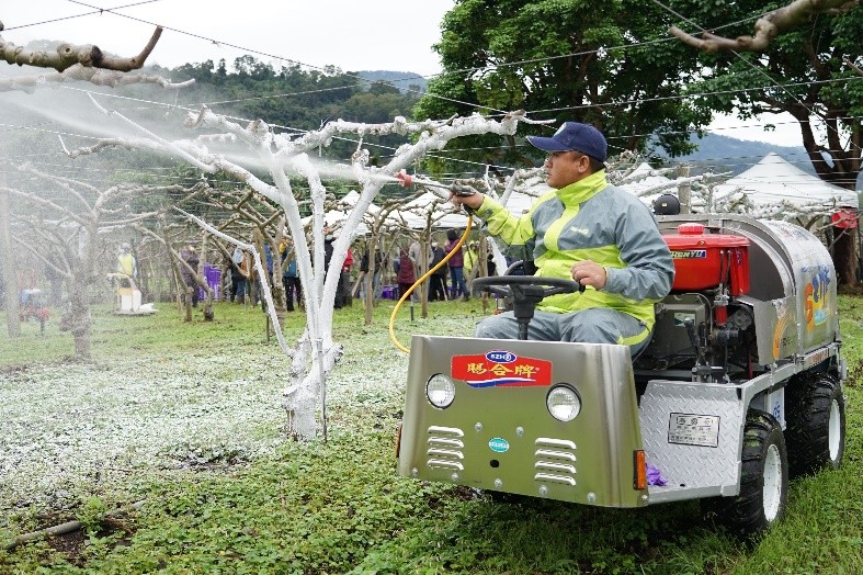 Figure 2. A demonstration of how to spray the whitewash onto tree branches from a vehicle.