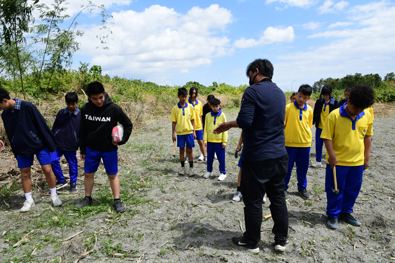 Lin explains techniques for planting seeds.